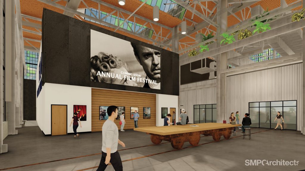 Digital mockup of an atrium with industrial design, featuring a large "Annual Film Festival" poster.